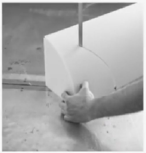 Shaping the corner of a foam cushion by hand