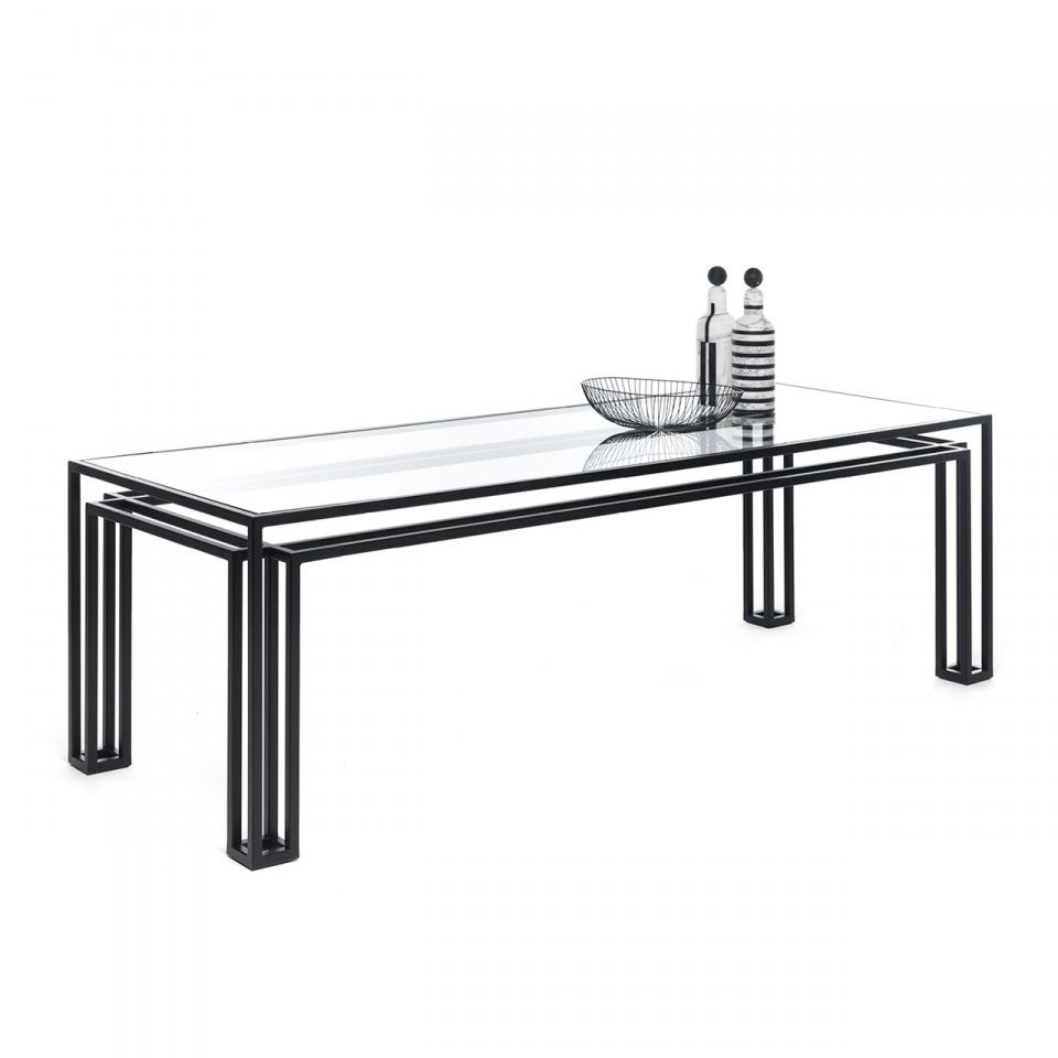 Brace Dining Table with a nested black steel frame and glass top