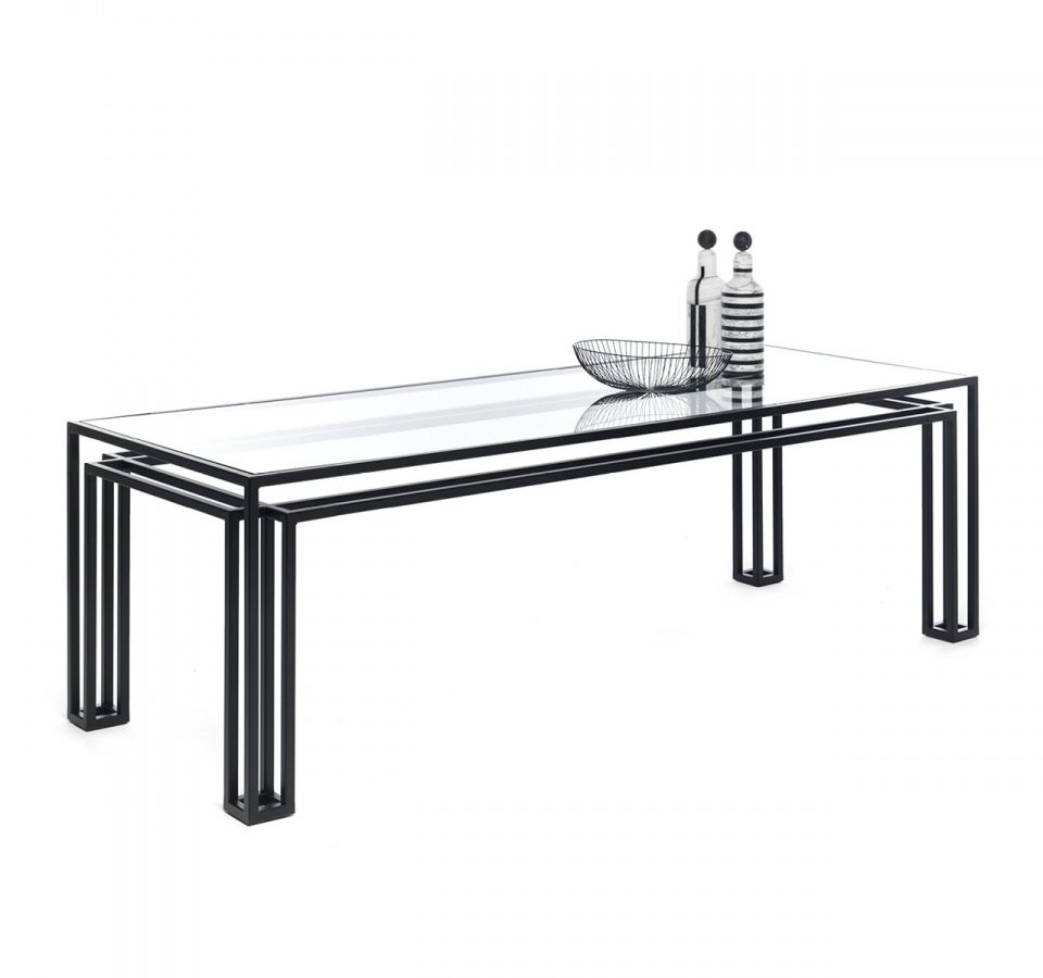 The Foundry Dining Table in matte blackened steel with a clear glass top