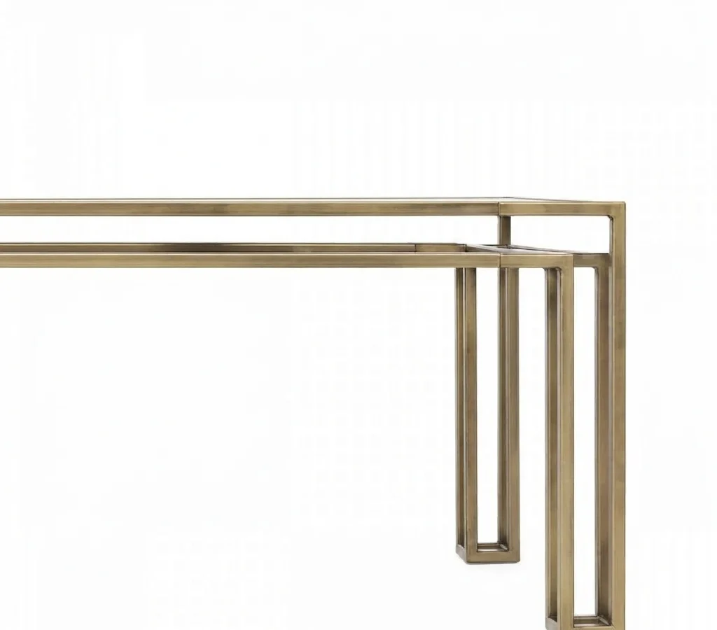Close-up of the Foundry frame in aged brass, the offset double rails meeting at the corner leg