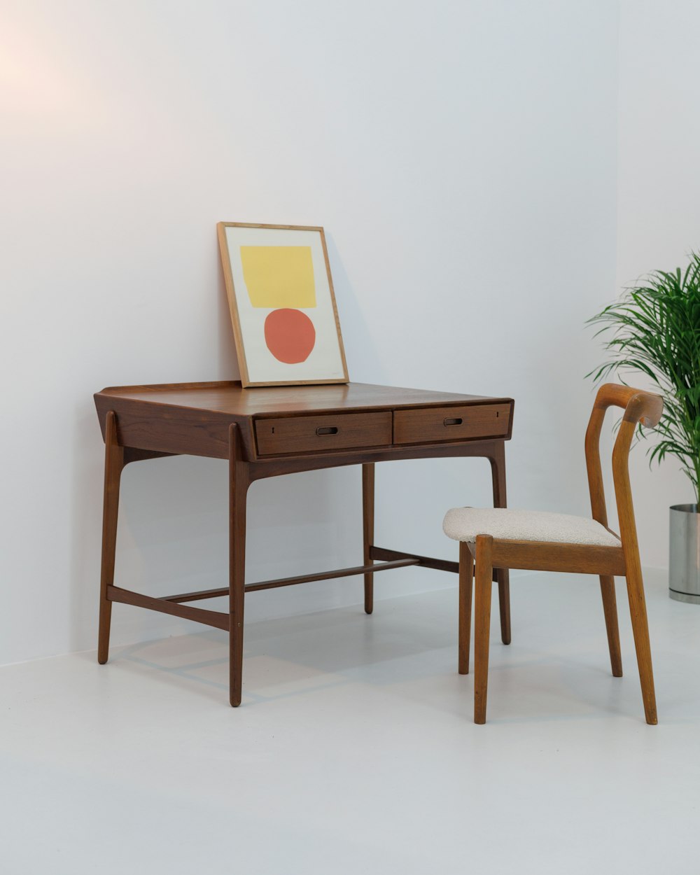 Loft Work Table — a desk with a chair and a potted plant