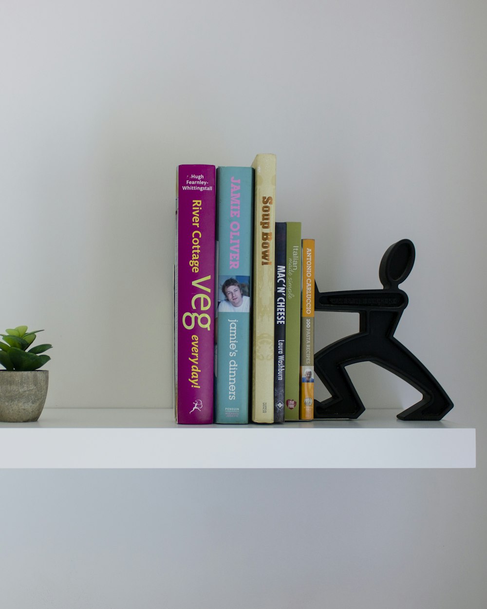 Reveal Shelving Unit — a white shelf with books