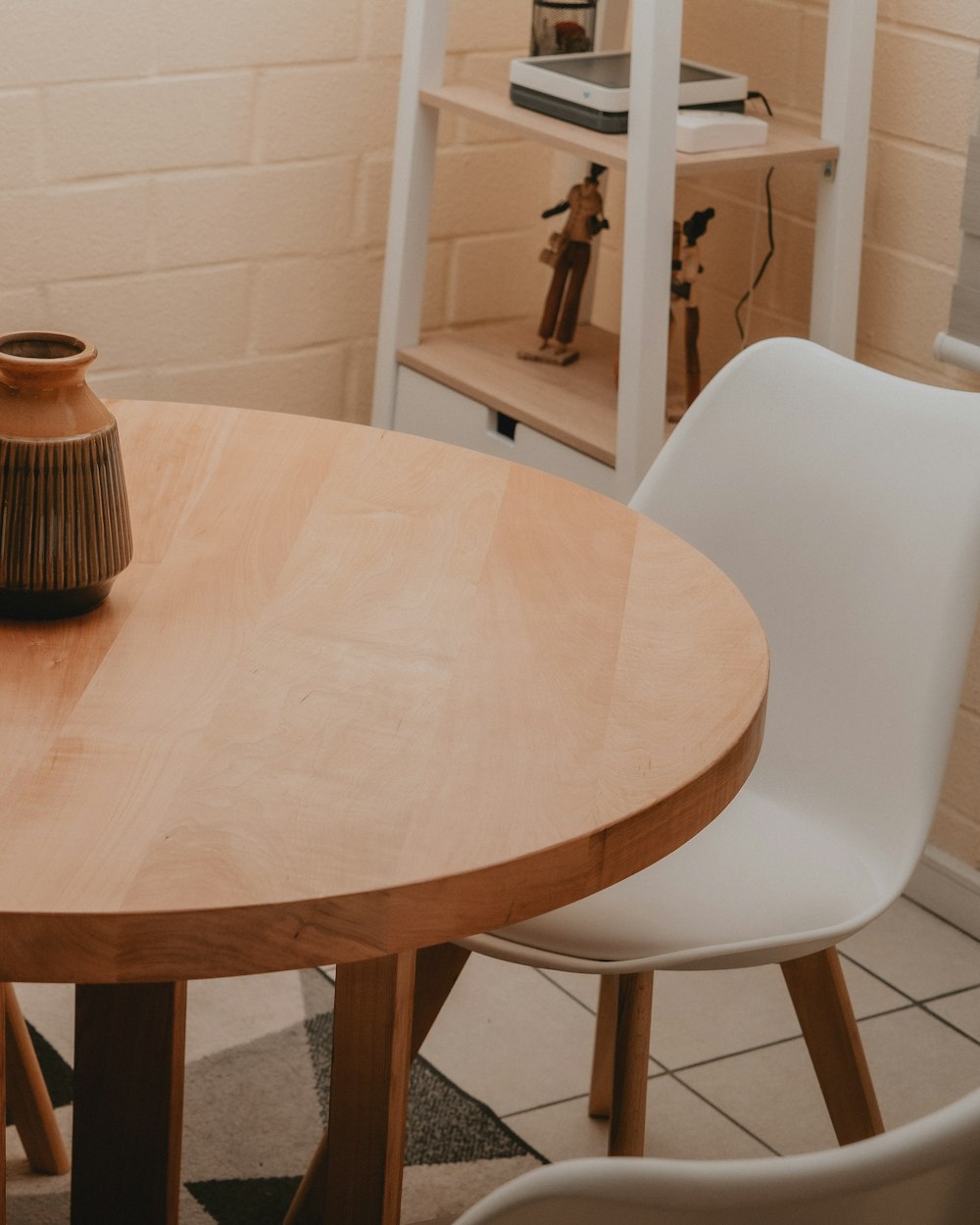 Truss Dining Table — a round table with a mug on it